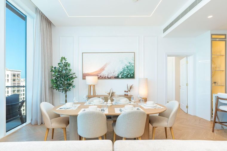 Dining area of a modern waterfront apartment with skyline views