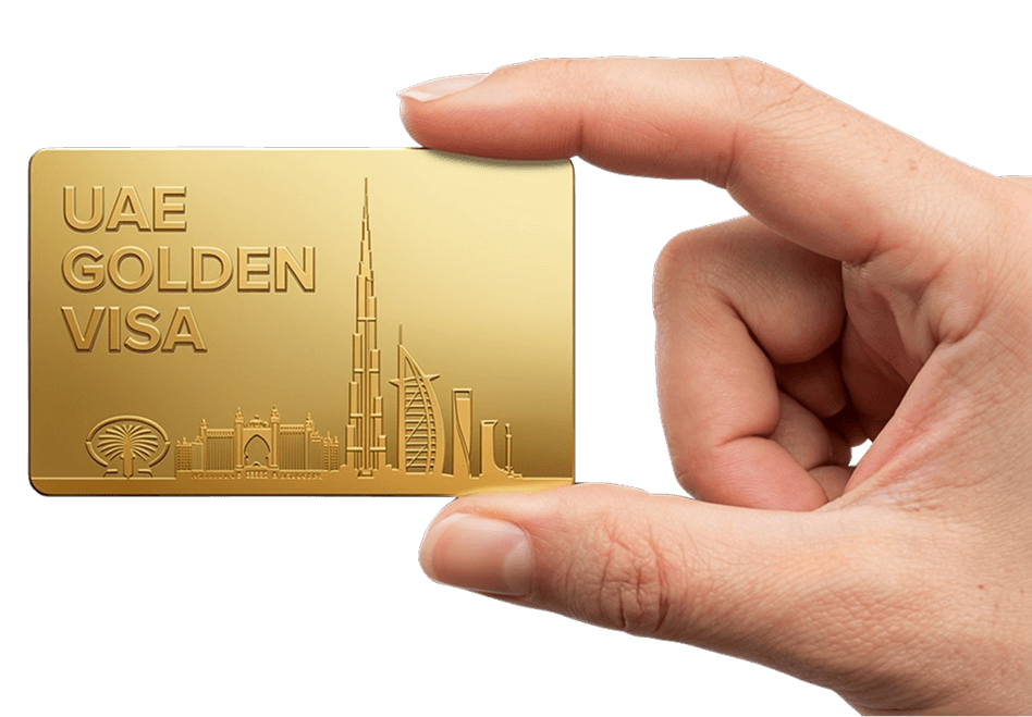 Hand holding a gold UAE Golden Visa card embossed with the Dubai skyline