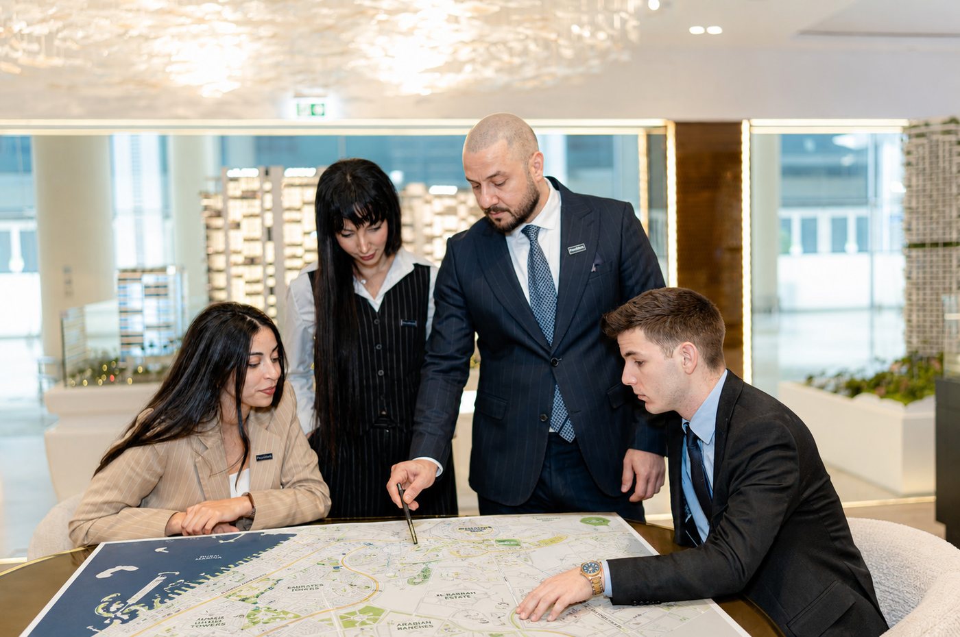 Provident advisors reviewing a Dubai community map with clients